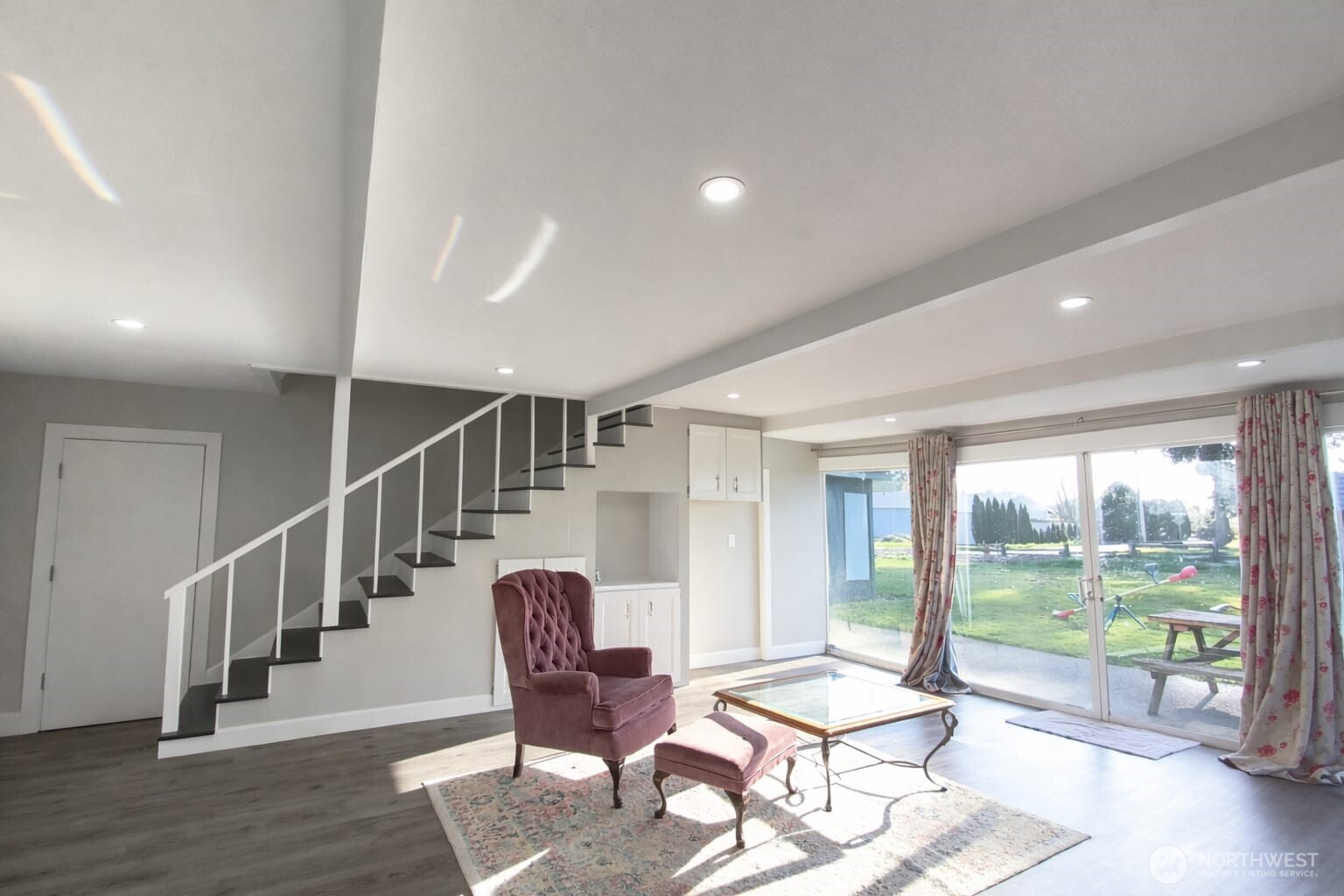 108 West Bartlett Road Lynden, WA 98264 - Photo 8 of 24 a living room with wooden floor and a table