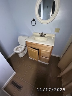 410 South Ralph Street Watseka, IL 60970 - Photo 12 of 18 a bathroom with a sink mirror vanity and toilet