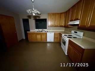 410 South Ralph Street Watseka, IL 60970 - Photo 3 of 18 a kitchen with granite countertop a sink dishwasher stove and cabinets