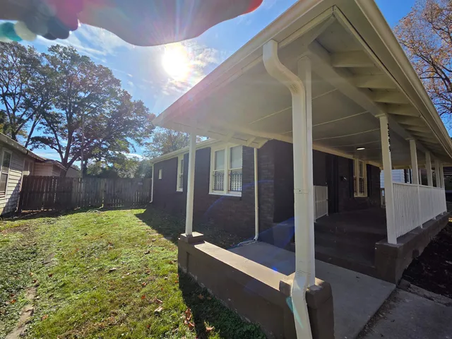 a view of backyard with patio