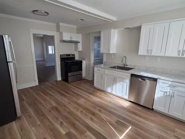 a bathroom with a sink mirror vanity and toilet