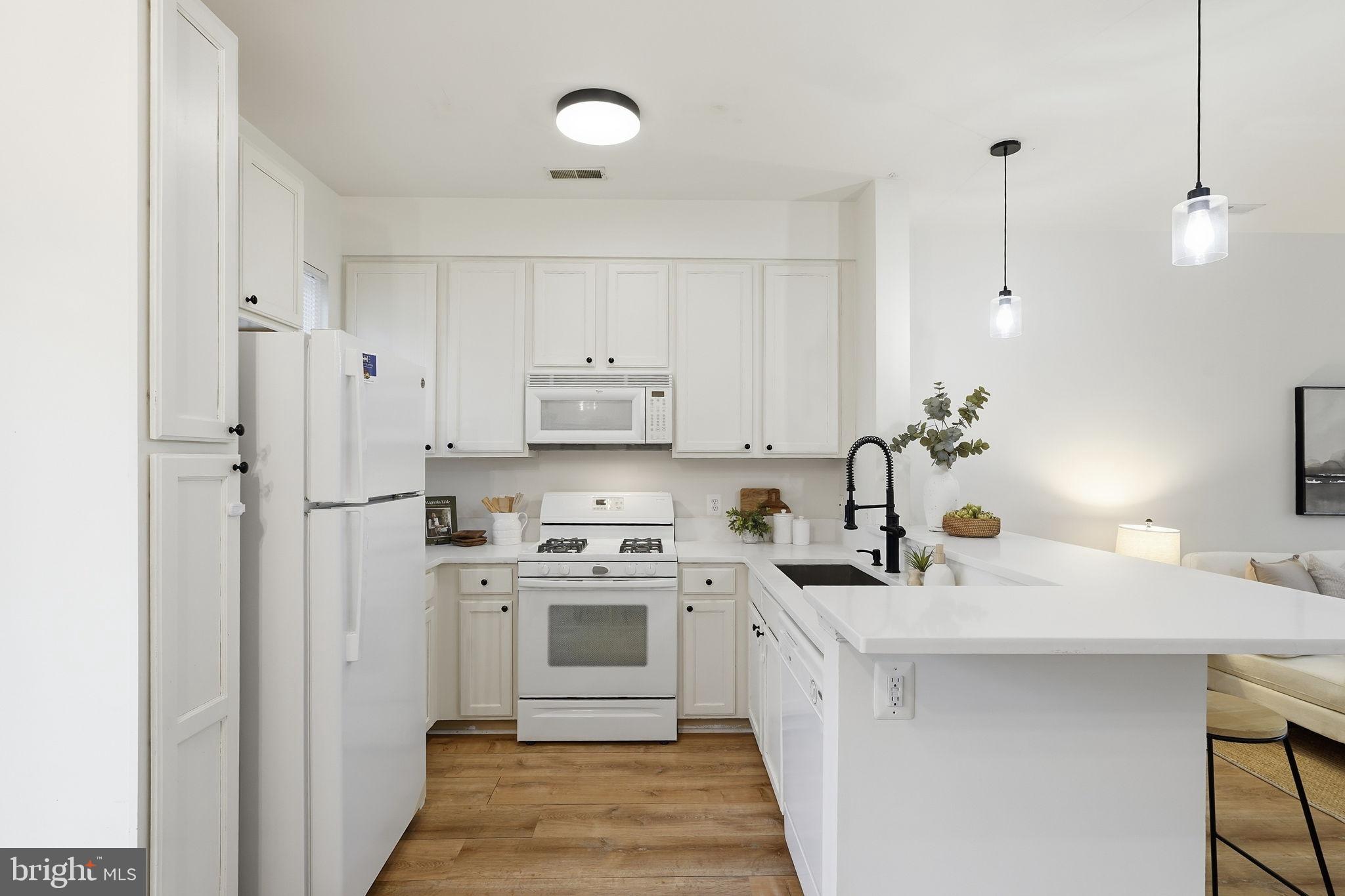 22987 Fontwell Square Sterling, VA 20166 - Photo 8 of 23 Modern kitchen with sleek white cabinetry.