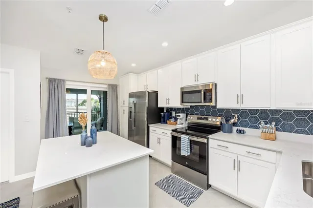 a dining room with a table chairs and a kitchen view