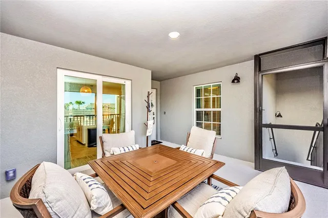 a kitchen with stainless steel appliances kitchen island granite countertop a stove top oven a sink dishwasher and white cabinets with wooden floor