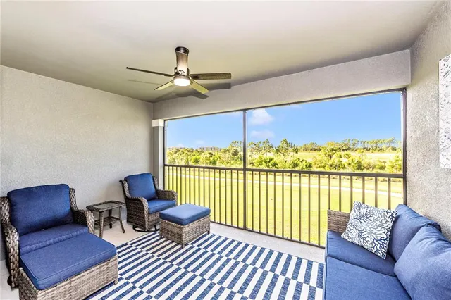 a front view of a house with glass windows and furniture