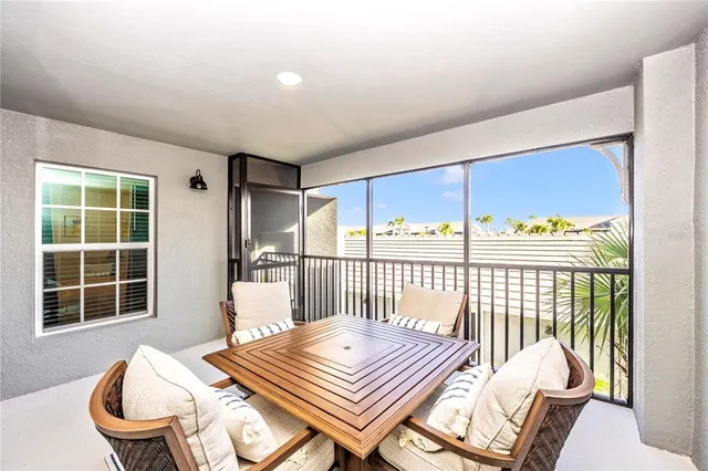 a kitchen with a refrigerator a sink dishwasher a oven and a dining table with wooden floor