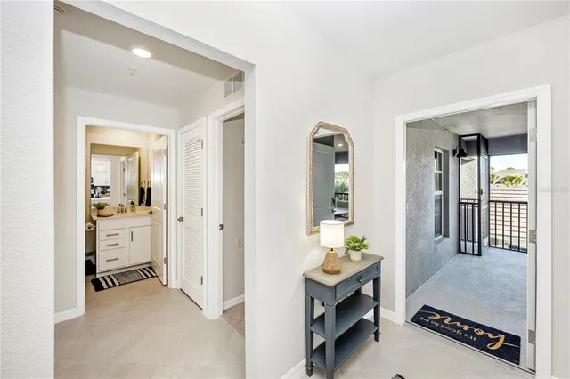 a kitchen with refrigerator a sink and chairs