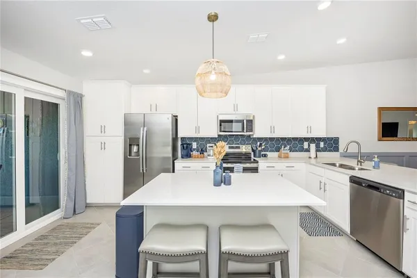 a kitchen with a sink a stove and cabinets