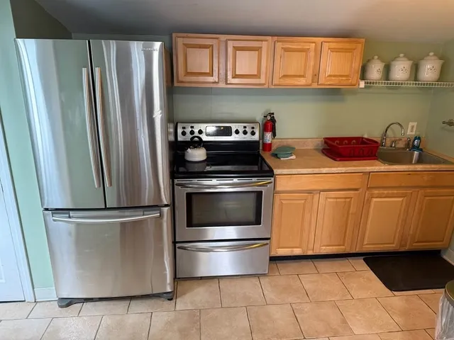 a kitchen with granite countertop a refrigerator and a stove