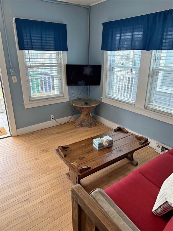 7 Dover Avenue, Unit 2 Hampton, NH 03842 - Photo 4 of 8 a living room with a bed furniture and a window