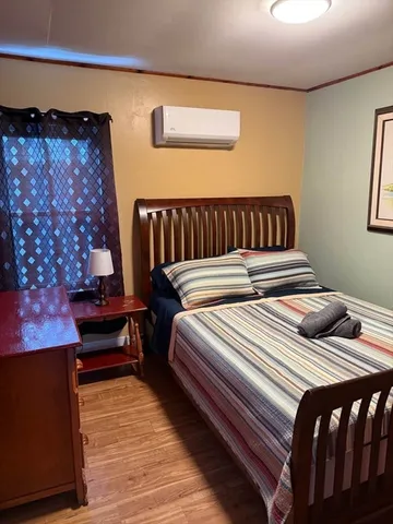 a bedroom with double bed and a lamp