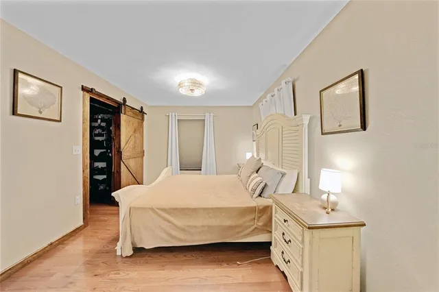 a bedroom with a bed and a night stand