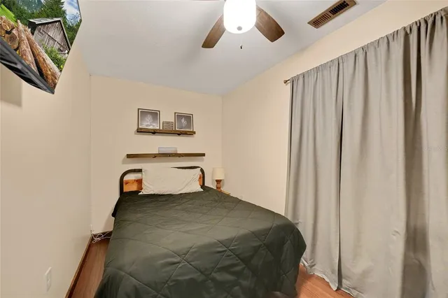 a bedroom with a bed and a painting on the wall