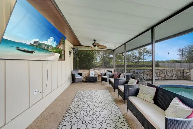 a living room with furniture and a floor to ceiling window