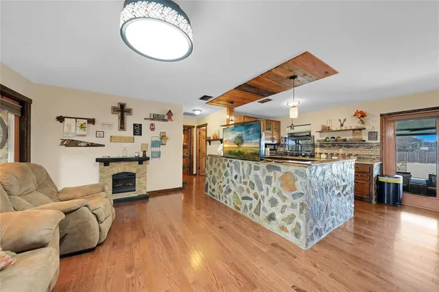 a living room with furniture and kitchen view