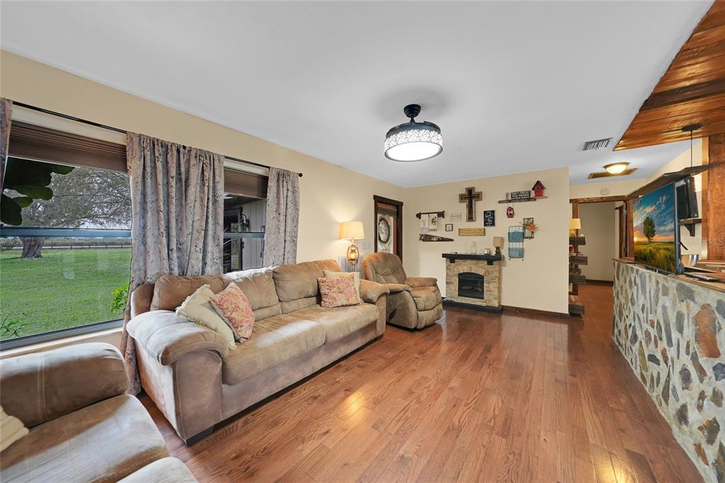7597 Highway 31 Arcadia, FL 34266 - Photo 4 of 45 a living room with furniture and a floor to ceiling window