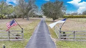 a view of a house with a yard and a garden