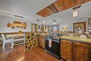 a kitchen with stainless steel appliances granite countertop a stove and cabinets