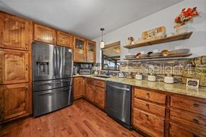 7597 Highway 31 Arcadia, FL 34266 - Photo 9 of 45 a kitchen with granite countertop stainless steel appliances and wooden cabinets