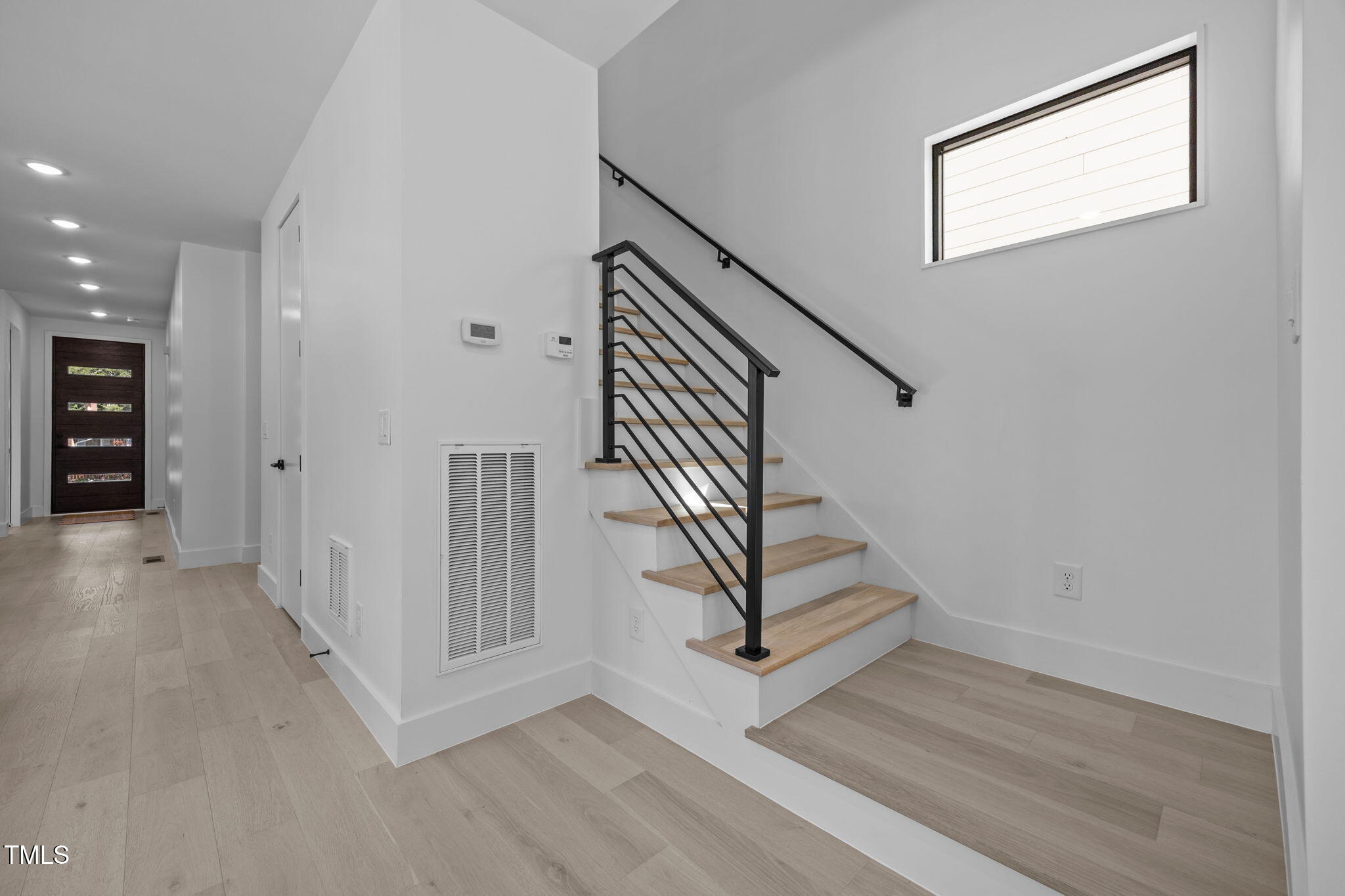 808 Culpepper Lane Raleigh, NC 27610 - Photo 16 of 27 a view of entryway with stairs and wooden floor