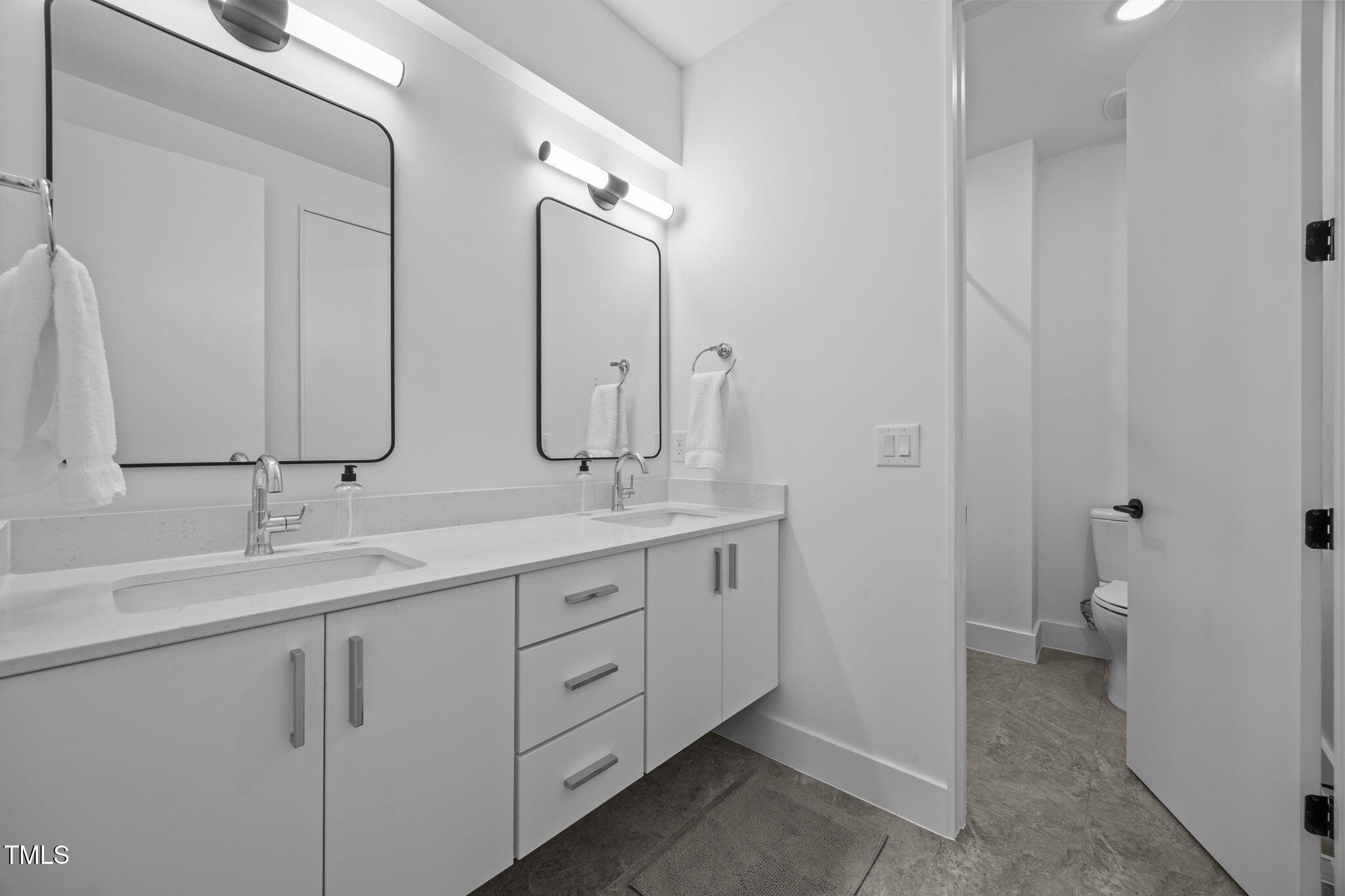 808 Culpepper Lane Raleigh, NC 27610 - Photo 21 of 27 a bathroom with a double vanity sink mirror and toilet