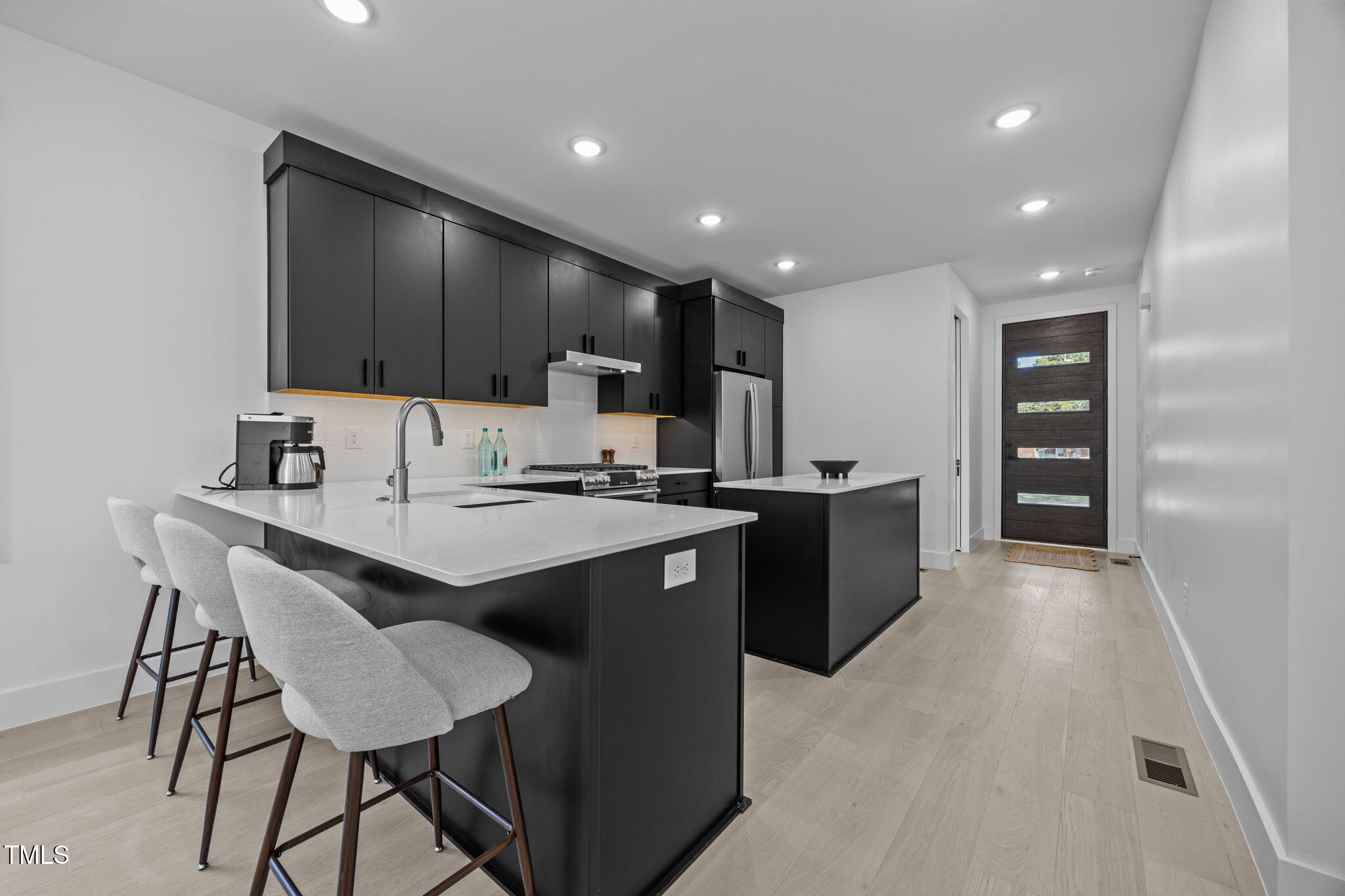 808 Culpepper Lane Raleigh, NC 27610 - Photo 7 of 27 a kitchen with stainless steel appliances kitchen island granite countertop a sink and a refrigerator