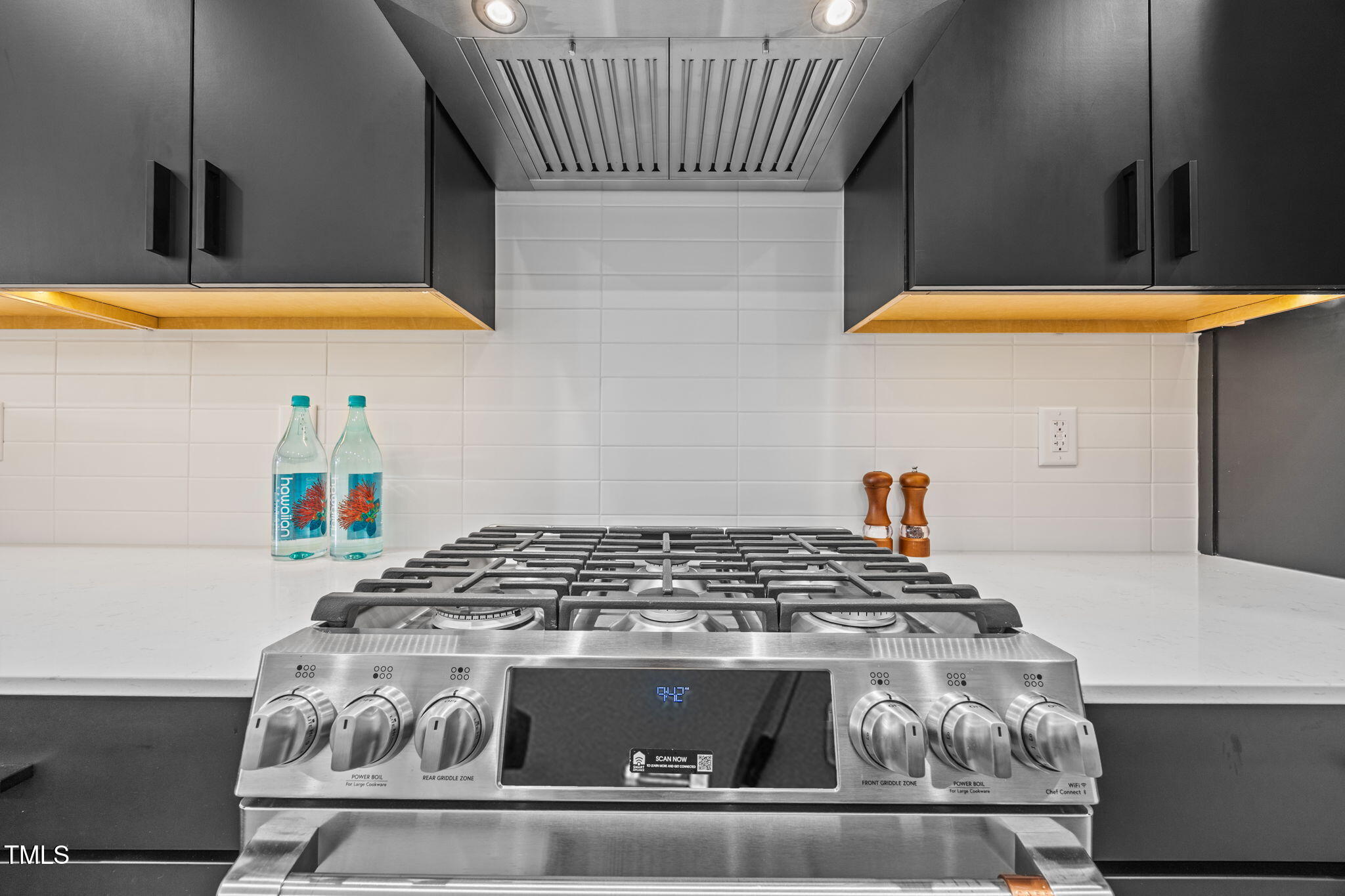 808 Culpepper Lane Raleigh, NC 27610 - Photo 9 of 27 a kitchen with a stove and a white cabinet