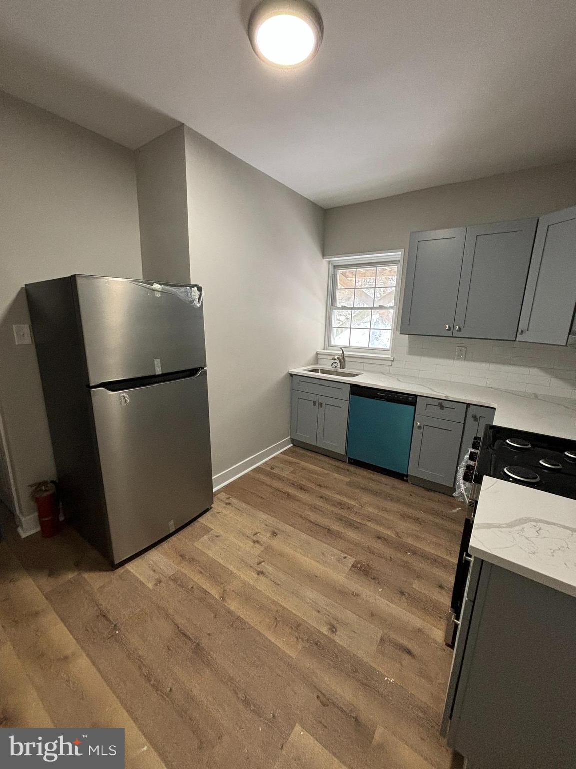 18 West 5th Street, Unit A/B Media, PA 19063 - Photo 4 of 12 a kitchen with stainless steel appliances granite countertop a refrigerator sink and cabinets