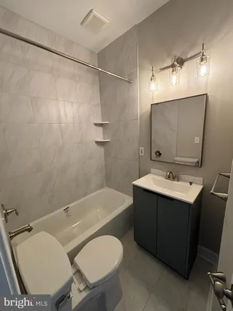 a bathroom with a sink toilet tub and shower