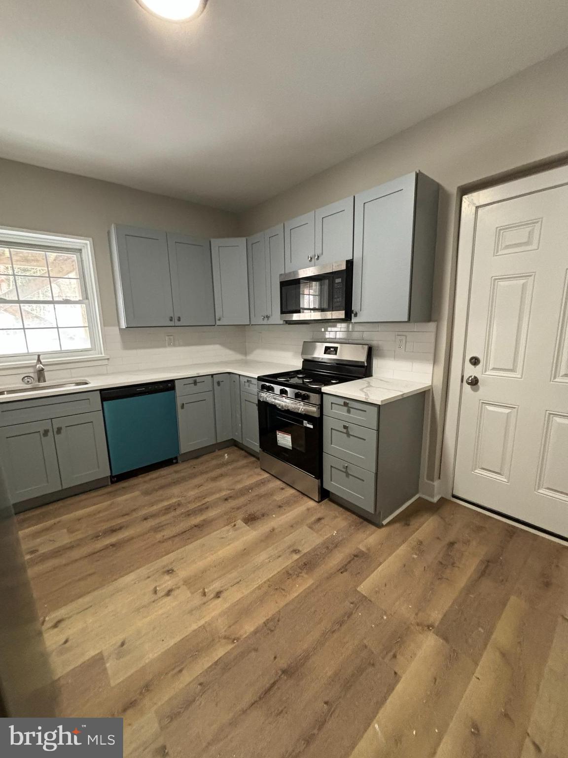 18 West 5th Street, Unit A/B Media, PA 19063 - Photo 9 of 12 a large kitchen with cabinets and stainless steel appliances
