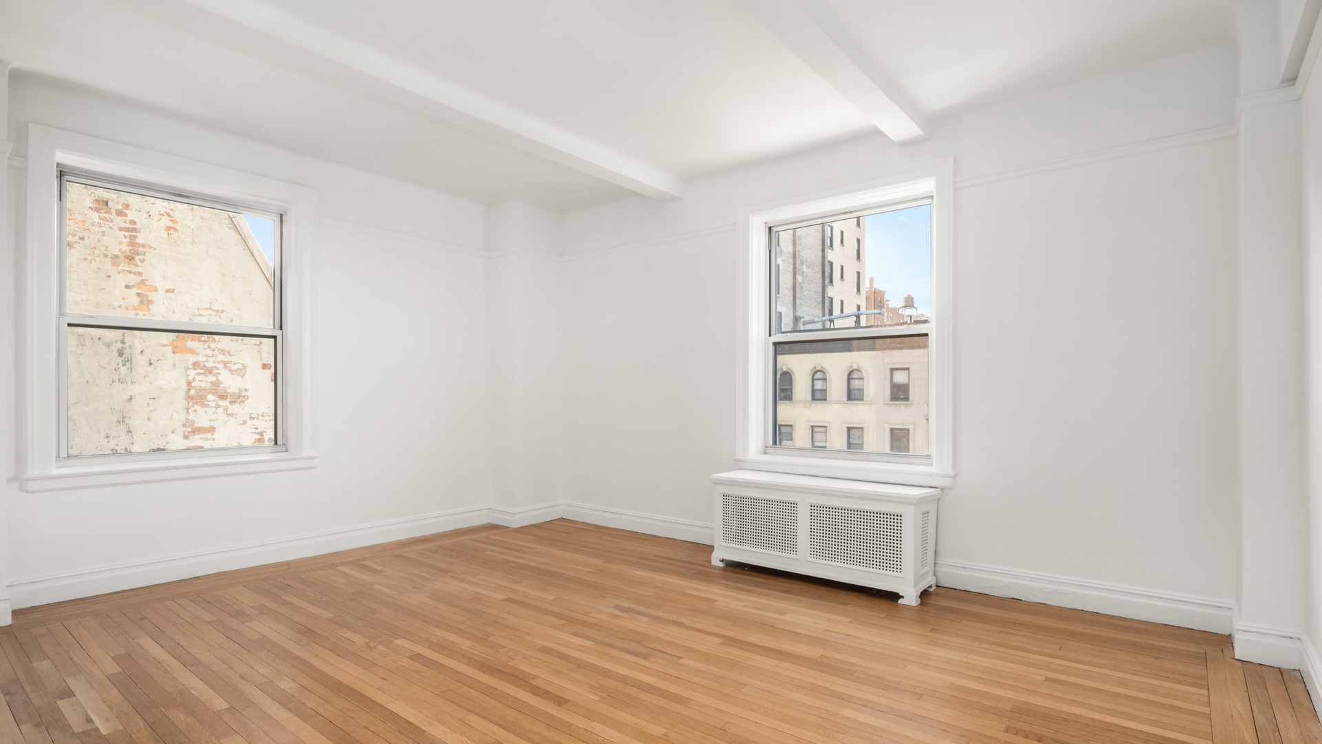 340 Riverside Drive, Unit 6D Manhattan, NY 10025 - Photo 8 of 26 an empty room with wooden floor and windows