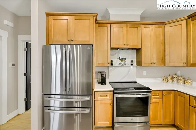 a kitchen with a refrigerator and a sink