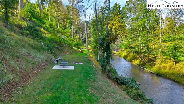a green field with lots of trees