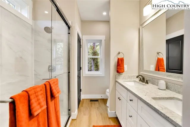 a bathroom with a granite countertop sink mirror and a bathtub