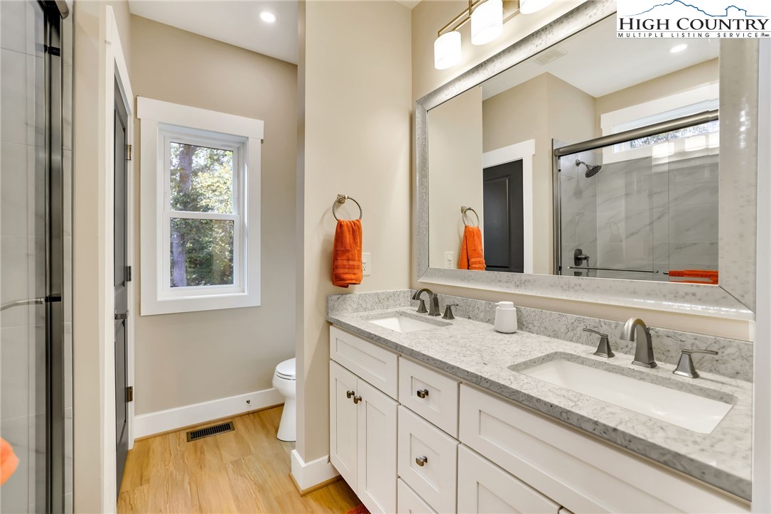379 Turtle Rdg Road Sparta, NC 28675 - Photo 35 of 43 a bathroom with a granite countertop sink mirror and a bathtub