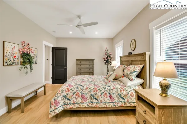 a bedroom with a bed a dresser and a window