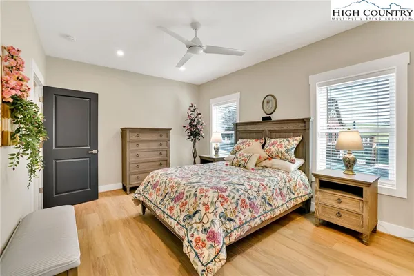 a bedroom with a large bed and a chandelier