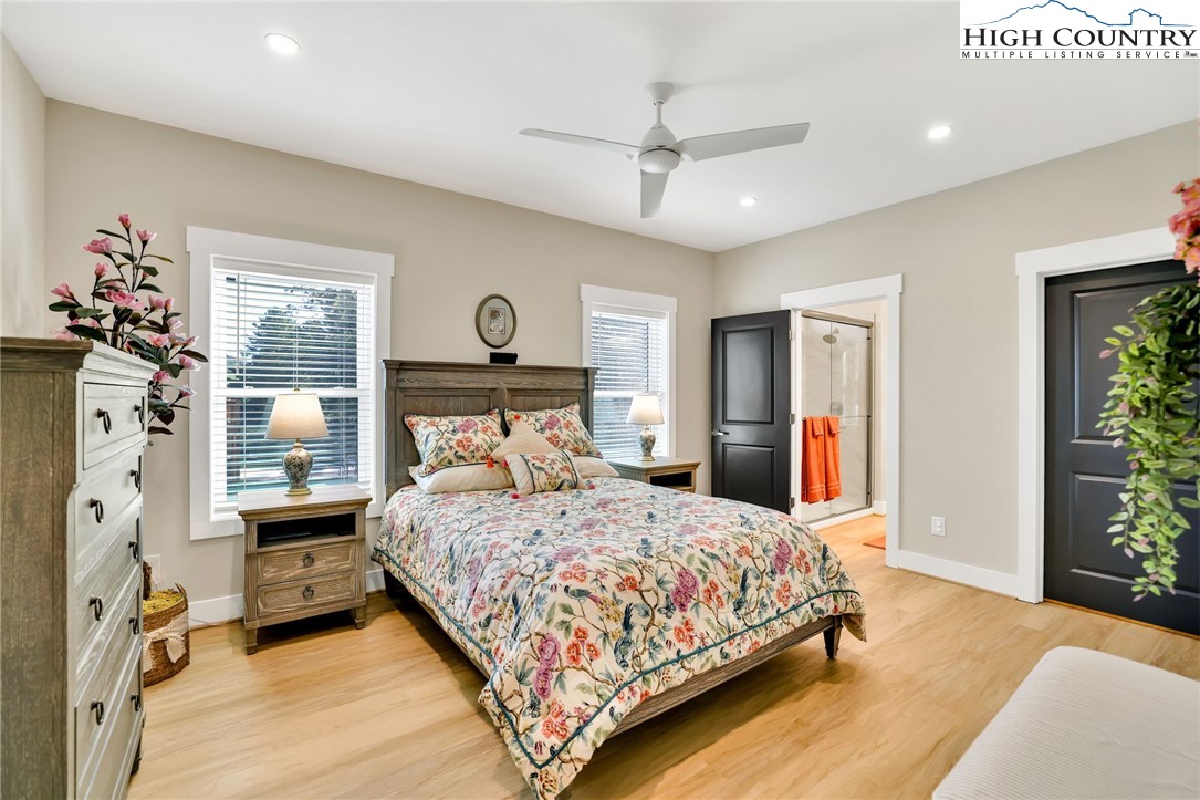 379 Turtle Rdg Road Sparta, NC 28675 - Photo 38 of 43 a bedroom with a large bed and a chandelier