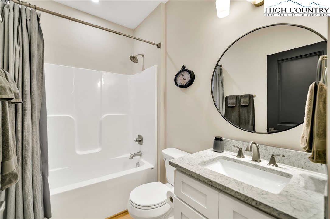 379 Turtle Rdg Road Sparta, NC 28675 - Photo 39 of 43 a bathroom with a granite countertop sink mirror toilet and bathtub