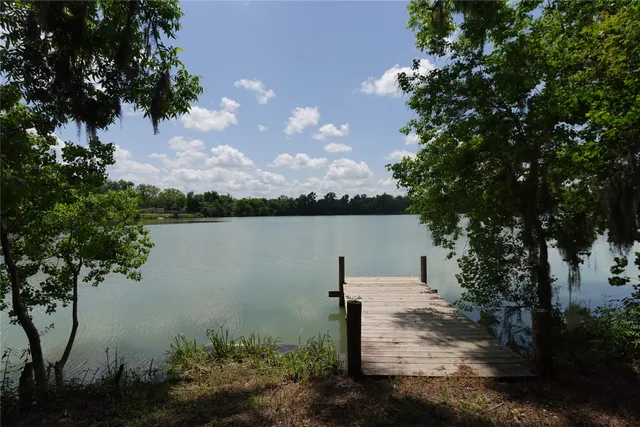 a view of a lake with a house in background