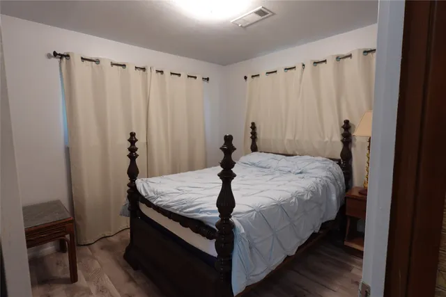 a bed sitting in a bedroom next to a window
