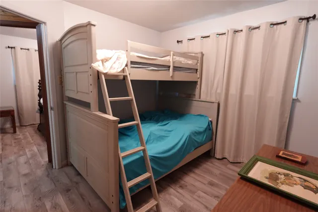 a bedroom with a bed and a mirror