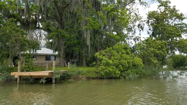 a view of a lake in between two trees