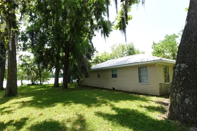 a view of backyard with a garden and trees