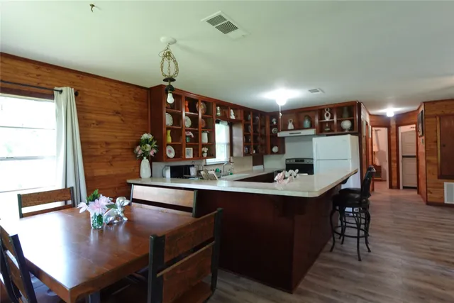 a dining table with chairs and wooden floor
