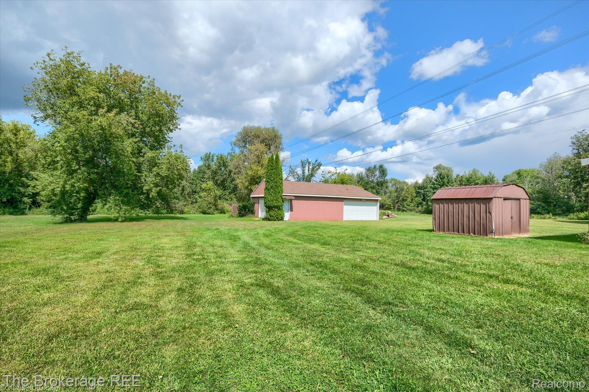 6129 East Lake Road Millington, MI 48746 - Photo 43 of 47 View of grassy yard with an outdoor structure and a detached garage