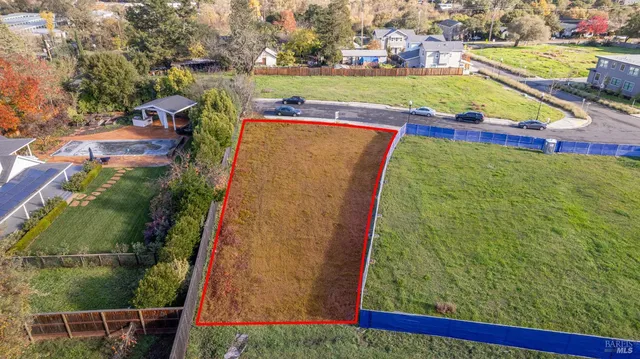 an aerial view of residential houses with outdoor space and swimming pool
