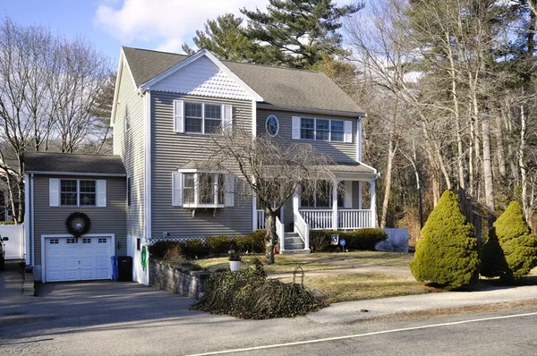 a front view of a house with a garden