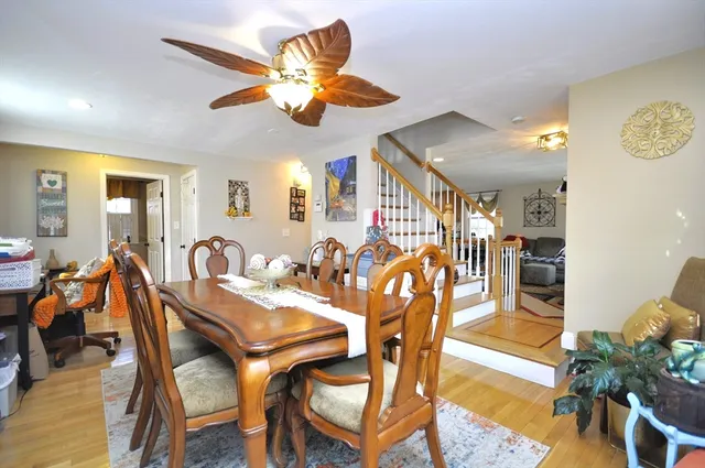 a view of a dining room and livingroom with furniture wooden floor a chandelier