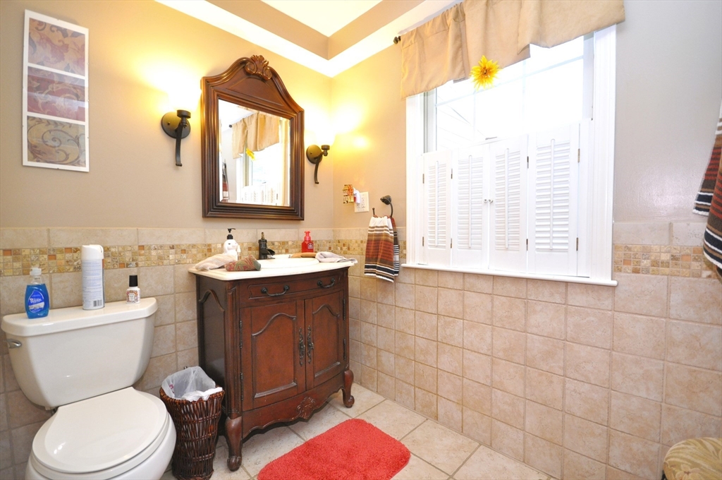 413 Harvard Street Whitman, MA 02382 - Photo 13 of 42 a bathroom with a toilet sink and mirror